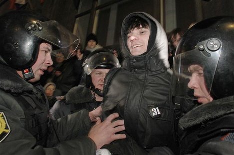 Police officers detain an activist during a protest rally defending Article 31 of the Russian constitution, which guarantees the right of as Police officers detain an activist during a protest rally defending Article 31 of the Russian constitution, which guarantees the right of as