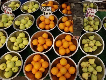 A market stall owner displays fruits in Leicester, central England A market stall owner displays fruits in Leicester, central England