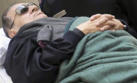 Former Egyptian President Mubarak lies on a gurney while leaving the courtroom at the police academy where he is on trial in Cairo Former Egyptian President Mubarak lies on a gurney while leaving the courtroom at the police academy where he is on trial in Cairo