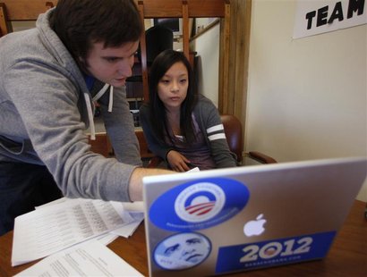 Supporters of U.S. President Obama, Cialeo and Krug, look over telephone call list to encourage Iowa Democrats to attend caucus night from p Supporters of U.S. President Obama, Cialeo and Krug, look over telephone call list to encourage Iowa Democrats to attend caucus night from p