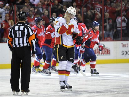 Flames' Bourque reacts as the Capitals celebrate Ovechkin's goal during their NHL hockey game in Washington. Flames' Bourque reacts as the Capitals celebrate Ovechkin's goal during their NHL hockey game in Washington.