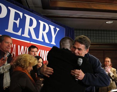Republican presidential candidate and Texas Governor Perry hugs former Marine Captain Moran during a campaign stop in Perry Republican presidential candidate and Texas Governor Perry hugs former Marine Captain Moran during a campaign stop in Perry