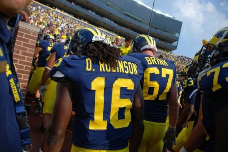 Denard Robinson and other Michigan players leave Michigan Stadium earlier this season. Denard Robinson and other Michigan players leave Michigan Stadium earlier this season.