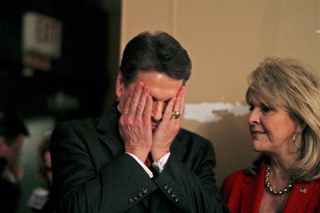 Texas Governor and Republican presidential candidate Perry puts his hands to his face before speaking to the West Des Moines Caucuses at the Texas Governor and Republican presidential candidate Perry puts his hands to his face before speaking to the West Des Moines Caucuses at the
