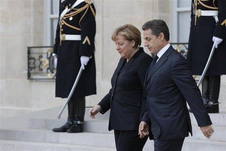 France's President Sarkozy escorts German Chancellor Merkel at the Elysee Palace following a joint news conference in Paris France's President Sarkozy escorts German Chancellor Merkel at the Elysee Palace following a joint news conference in Paris