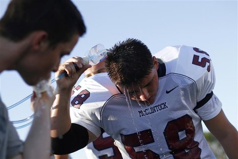 A McClintock High School Chargers football player cools down during a practice session in Tempe A McClintock High School Chargers football player cools down during a practice session in Tempe