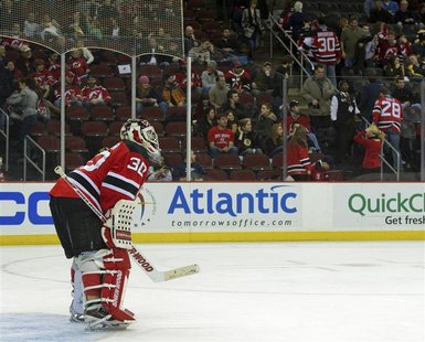 Fans near Devils goalie Brodeur leave the arena in the third period of their NHL hockey game in Newark. Fans near Devils goalie Brodeur leave the arena in the third period of their NHL hockey game in Newark.