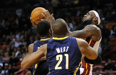 Miami Heat's LeBron James is defended by Indiana Pacers's George and West during their NBA basketball game in Miami. Miami Heat's LeBron James is defended by Indiana Pacers's George and West during their NBA basketball game in Miami.