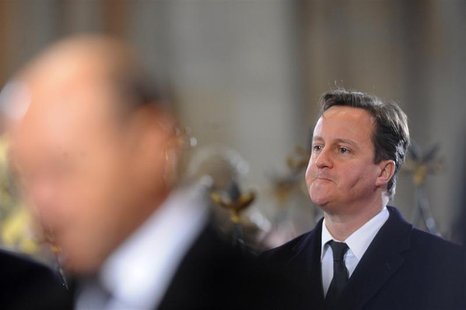 British Prime Minister Cameron reacts during the state funeral of former Czech President Havel at Prague Castle's St. Vitus Cathedral