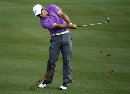 Casey of England hits his second shot at the eighth hole during the final round of the Dubai World Championship in Dubai