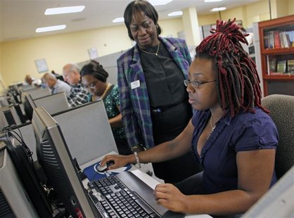 Smith fills out an online job application with the help of career consultant Coleman at the Workforce Alliance Career Center in West Palm Be Smith fills out an online job application with the help of career consultant Coleman at the Workforce Alliance Career Center in West Palm Be