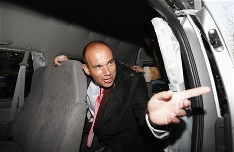 Former Olympus CEO Michael Woodford speaks to a reporter from inside a van as he leaves a news conference in Tokyo Former Olympus CEO Michael Woodford speaks to a reporter from inside a van as he leaves a news conference in Tokyo