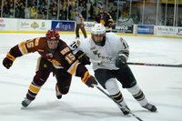 Western Michigan's Chase Balisy challenges Minneota-Duluth's Jake Hendrickson at Lawson Arena, Jan 6, 2012.  The Bulldogs prevailed 4-1.  Photo by Sean Patrick Duross.