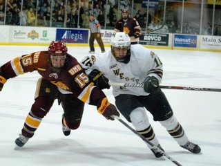 Western Michigan's Chase Balisy challenges Minneota-Duluth's Jake Hendrickson at Lawson Arena, Jan 6, 2012.  The Bulldogs prevailed 4-1.  Photo by Sean Patrick Duross.