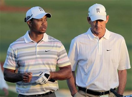 Woods of the U.S. walks off the driving range with his swing coach Haney before his practice round for the 2010 Masters golf tournament at t Woods of the U.S. walks off the driving range with his swing coach Haney before his practice round for the 2010 Masters golf tournament at t