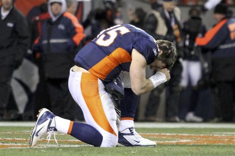 Denver Broncos quarterback Tim Tebow prays after the Broncos defeated the Pittsburgh Steelers in overtime in the NFL AFC wildcard playoff fo Denver Broncos quarterback Tim Tebow prays after the Broncos defeated the Pittsburgh Steelers in overtime in the NFL AFC wildcard playoff fo