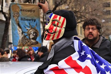 Protesters, one in a Guy Fawkes mask, affiliated with the Occupy Wall Street movement, protest around Duarte Square in New York Protesters, one in a Guy Fawkes mask, affiliated with the Occupy Wall Street movement, protest around Duarte Square in New York