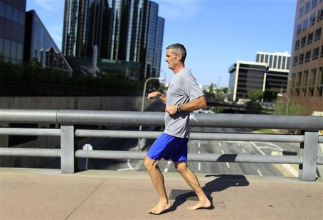 A man runs barefoot in downtown Los Angeles A man runs barefoot in downtown Los Angeles