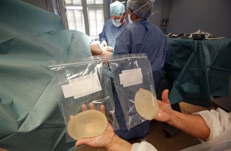 A nurse displays cleaned defective silicone gel breast implants, manufactured by French company Poly Implant Prothese (PIP), is seen near su A nurse displays cleaned defective silicone gel breast implants, manufactured by French company Poly Implant Prothese (PIP), is seen near su