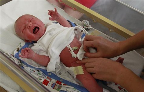 Newborn baby boy is examined by a paediatrician in the maternity ward in Huntingdon Newborn baby boy is examined by a paediatrician in the maternity ward in Huntingdon