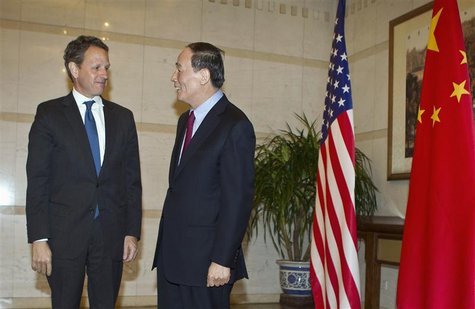 U.S. Treasury Secretary Timothy Geithner chats with Chinese Vice Premier Wang Qishan before a dinner at the Diaoyutai State Guesthouse in Be U.S. Treasury Secretary Timothy Geithner chats with Chinese Vice Premier Wang Qishan before a dinner at the Diaoyutai State Guesthouse in Be