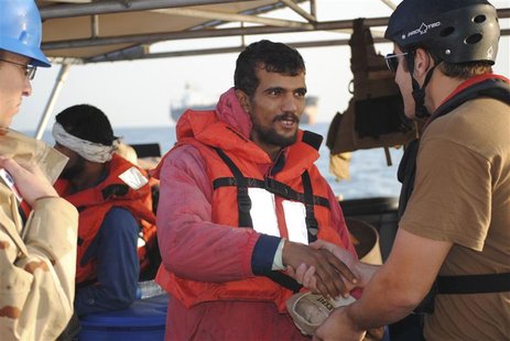 An Iranian mariner greets a U.S. Coast Guardsman from the U.S. Coast Guard Cutter Monomoy in the Arabian Gulf An Iranian mariner greets a U.S. Coast Guardsman from the U.S. Coast Guard Cutter Monomoy in the Arabian Gulf