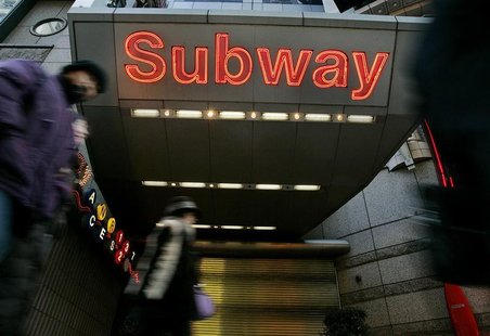 People walk past the closed entrance to the Times Square subway station during the second day of the.. People walk past the closed entrance to the Times Square subway station during the second day of the..