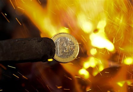 An illustration picture shows a one Euro coin being melted by a smith in Skopje An illustration picture shows a one Euro coin being melted by a smith in Skopje