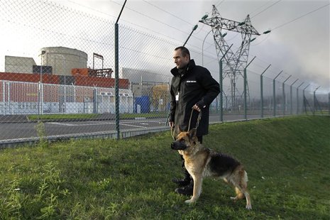 An employee of Securit Dog Man company patrols along a fence inside the Chinon Nuclear Power Plant in Chinon An employee of Securit Dog Man company patrols along a fence inside the Chinon Nuclear Power Plant in Chinon