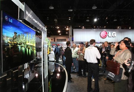 Showgoers look at a display of 55-inch 3D OLED televisions at the LG Electronics booth during the 2012 International Consumer Electronics Sh