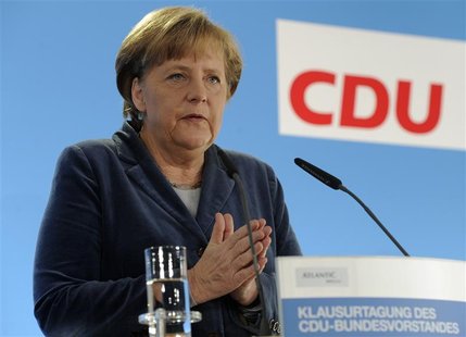 German Chancellor and leader of the Christian Democratic Party (CDU) Merkel gestures as she addresses the media during a party convention in German Chancellor and leader of the Christian Democratic Party (CDU) Merkel gestures as she addresses the media during a party convention in