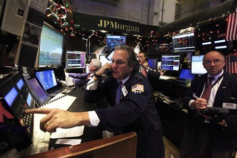 Specialists and traders work at the JP Morgan stall on the floor of the New York Stock Exchange Specialists and traders work at the JP Morgan stall on the floor of the New York Stock Exchange