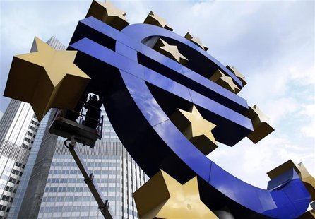 Workers maintain the huge Euro logo in front headquarters of ECB in Frankfurt Workers maintain the huge Euro logo in front headquarters of ECB in Frankfurt