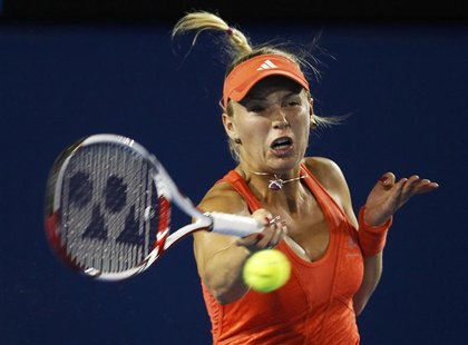 Wozniacki of Denmark hits a return to Rodionova of Australia during their women's singles match at the Australian Open tennis tournament in Wozniacki of Denmark hits a return to Rodionova of Australia during their women's singles match at the Australian Open tennis tournament in