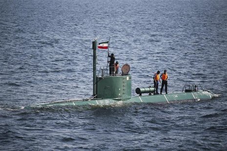 Military personnel place a flag on a submarine during the Velayat-90 war games by the Iranian navy in the Strait of Hormuz in southern Iran Military personnel place a flag on a submarine during the Velayat-90 war games by the Iranian navy in the Strait of Hormuz in southern Iran