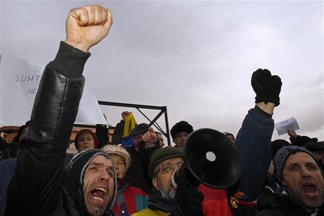 People shout slogans during a protest against Romania's President Basescu at the University Square in Bucharest People shout slogans during a protest against Romania's President Basescu at the University Square in Bucharest