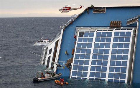 Rescue workers climbs up the capsized Costa Concordia cruise ship that ran aground off Giglio island Rescue workers climbs up the capsized Costa Concordia cruise ship that ran aground off Giglio island