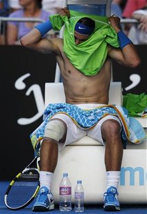Nadal of Spain changes his shirt during his men's singles match against Kuznetsov of the U.S. at the Australian Open tennis tournament in Me Nadal of Spain changes his shirt during his men's singles match against Kuznetsov of the U.S. at the Australian Open tennis tournament in Me