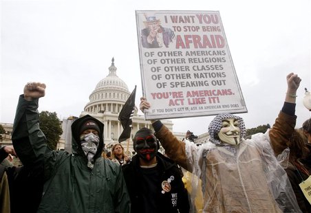 Occupy Congress/DC protesters hold up a sign in front of the U.S. Capitol during a rally in Washington Occupy Congress/DC protesters hold up a sign in front of the U.S. Capitol during a rally in Washington