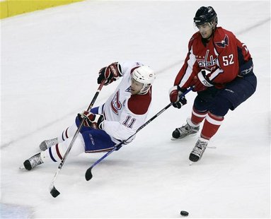 Montreal Canadiens Saku Koivu can't get to the puck before Washington Capitals Mike Green during the second period of their NHL hockey actio Montreal Canadiens Saku Koivu can't get to the puck before Washington Capitals Mike Green during the second period of their NHL hockey actio
