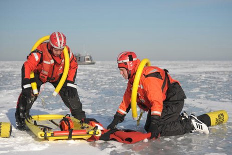 Petty Officer 2nd Class Nick Schierberg and Seaman Grant Jansen, both of Coast Guard Station Sturgeon Bay, Wis., simulate evacuating a victim during a mass rescue operations preparedness exercise at Red River County Park, Jan. 18, 2012. Petty Officer 2nd Class Nick Schierberg and Seaman Grant Jansen, both of Coast Guard Station Sturgeon Bay, Wis., simulate evacuating a victim during a mass rescue operations preparedness exercise at Red River County Park, Jan. 18, 2012.