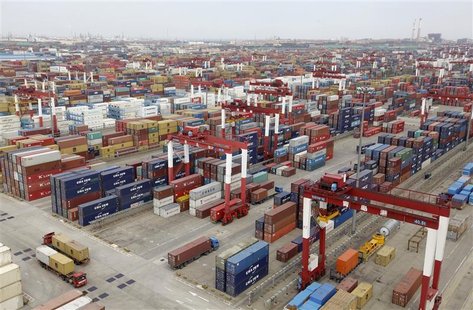 Trucks are driven into a shipping container area at Qingdao port Trucks are driven into a shipping container area at Qingdao port
