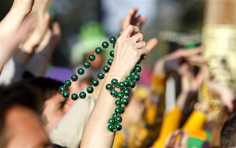In this file picture, a reveler catches a pair of beads on St. Charles Avenue the weekend before Mardi Gras Day in New Orleans, Louisiana In this file picture, a reveler catches a pair of beads on St. Charles Avenue the weekend before Mardi Gras Day in New Orleans, Louisiana