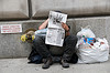 Homeless man with paper