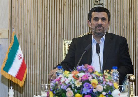 Iran's President Mahmoud Ahmadinejad speaks with journalists at Tehran's Mehrabad airport after his visit to Latin American countries