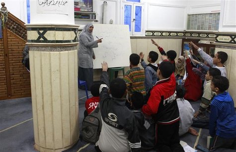 A teacher and volunteer from the Muslim Brotherhood revises lessons for free with school pupils before their exams, at a mosque in Alexandri A teacher and volunteer from the Muslim Brotherhood revises lessons for free with school pupils before their exams, at a mosque in Alexandri