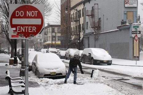 A man cleans the street during a snow storm in Jersey City A man cleans the street during a snow storm in Jersey City