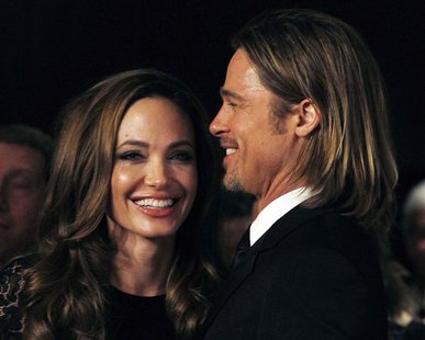 Actress Angelina Jolie smiles with her partner Brad Pitt as they arrive at the 23rd annual Producers Guild Awards in Beverly Hills Actress Angelina Jolie smiles with her partner Brad Pitt as they arrive at the 23rd annual Producers Guild Awards in Beverly Hills