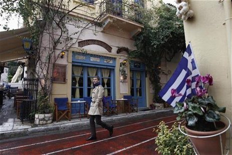 A man walks in front of a cafe at Plaka tourist district in Athens A man walks in front of a cafe at Plaka tourist district in Athens