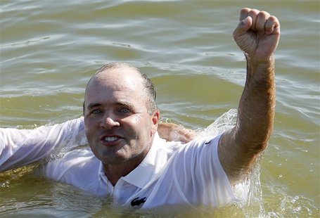 France's Levet celebrates after jumping into the lake following his win at the French Open golf tournament at the Golf National course in Sa France's Levet celebrates after jumping into the lake following his win at the French Open golf tournament at the Golf National course in Sa